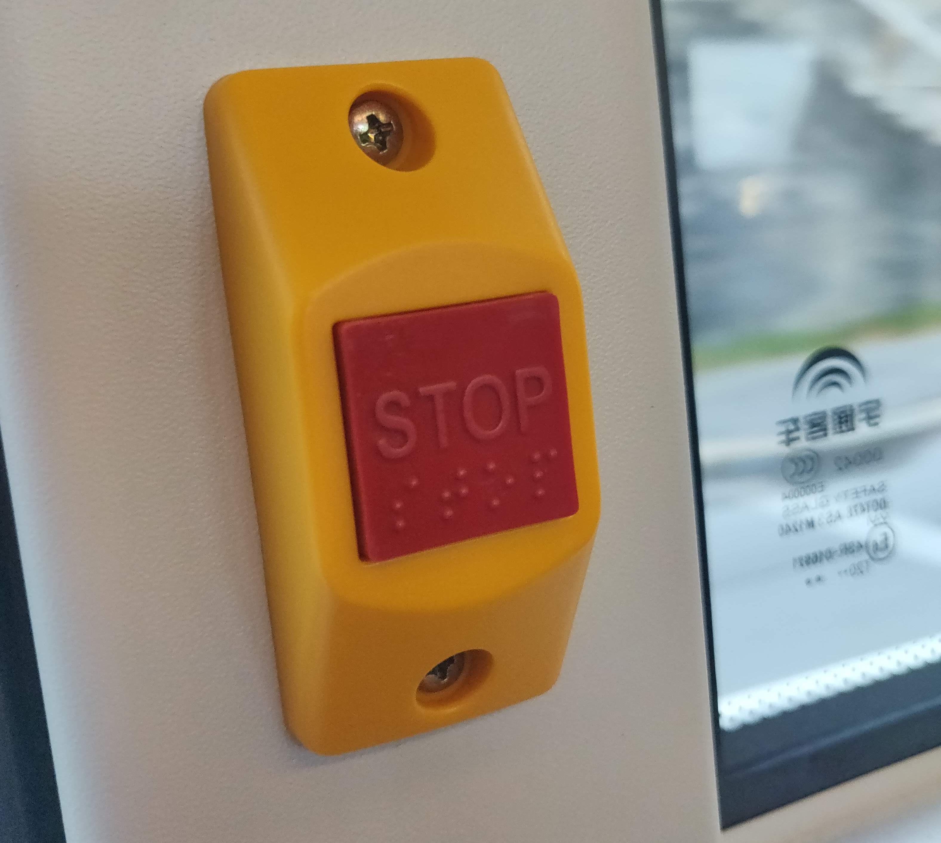 Bilde av en kjedelig knapp med teksten: STOP og punktskrift: STOP